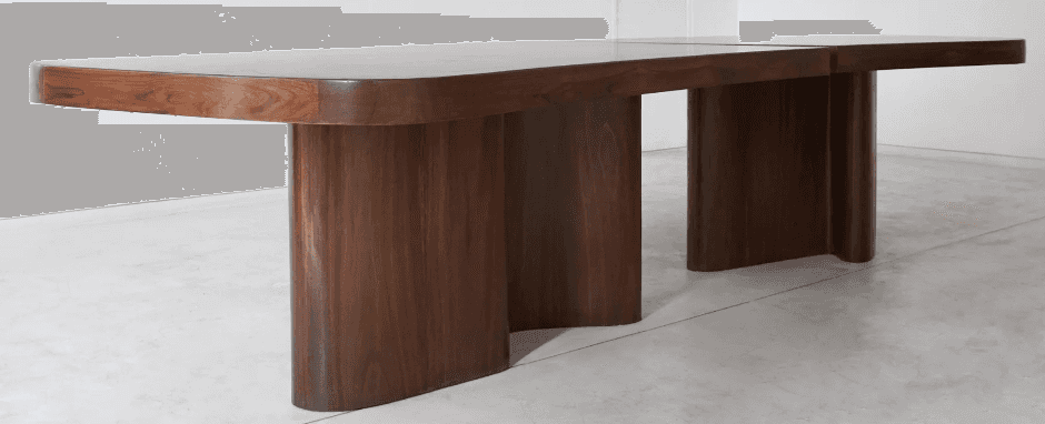 A modern dining table with a rich walnut finish, featuring a rectangular top with softly rounded cor… — 3D model