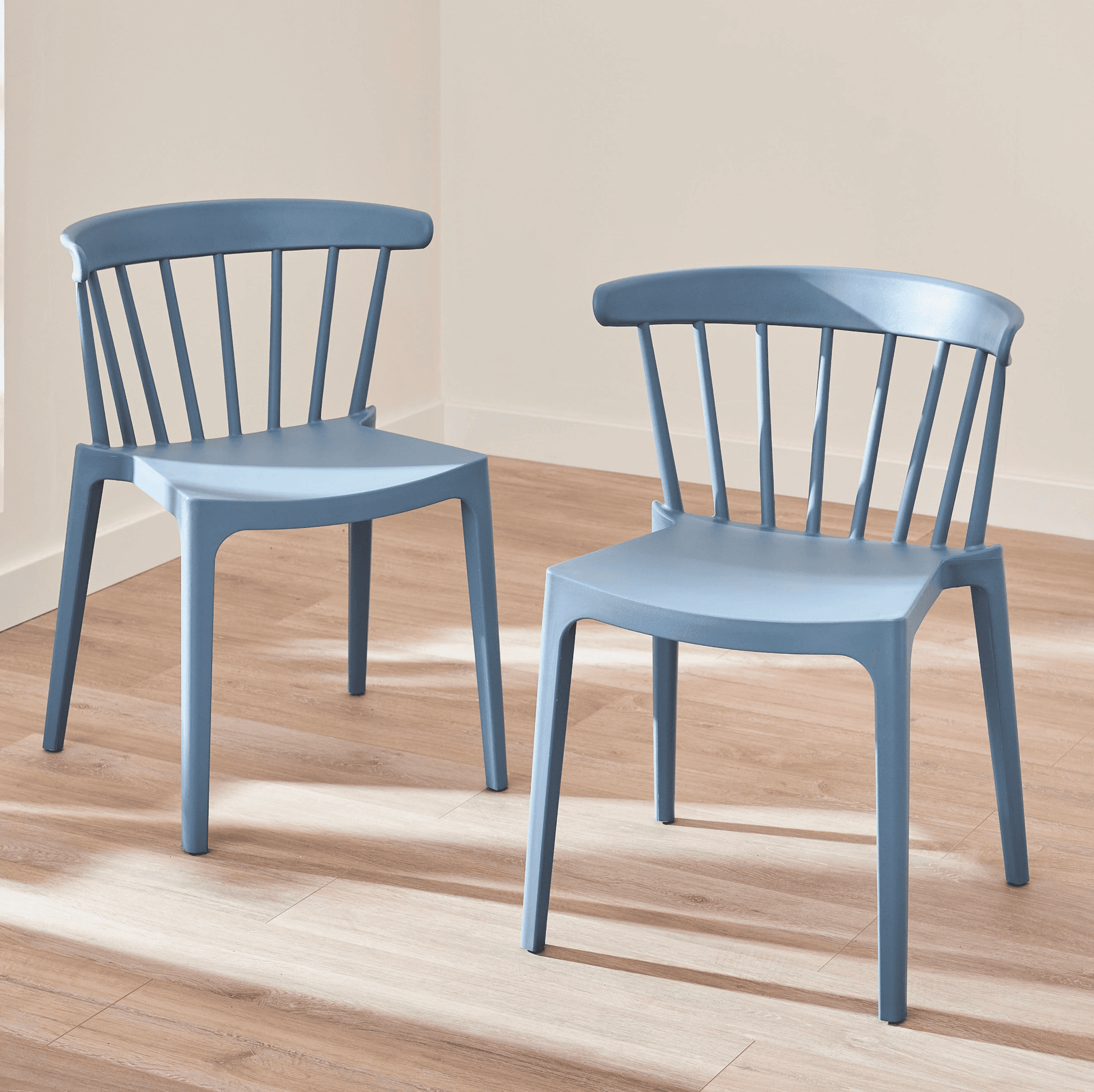 A contemporary dining chair in a muted blue hue, constructed from molded plastic with a spindle-styl… — 3D model