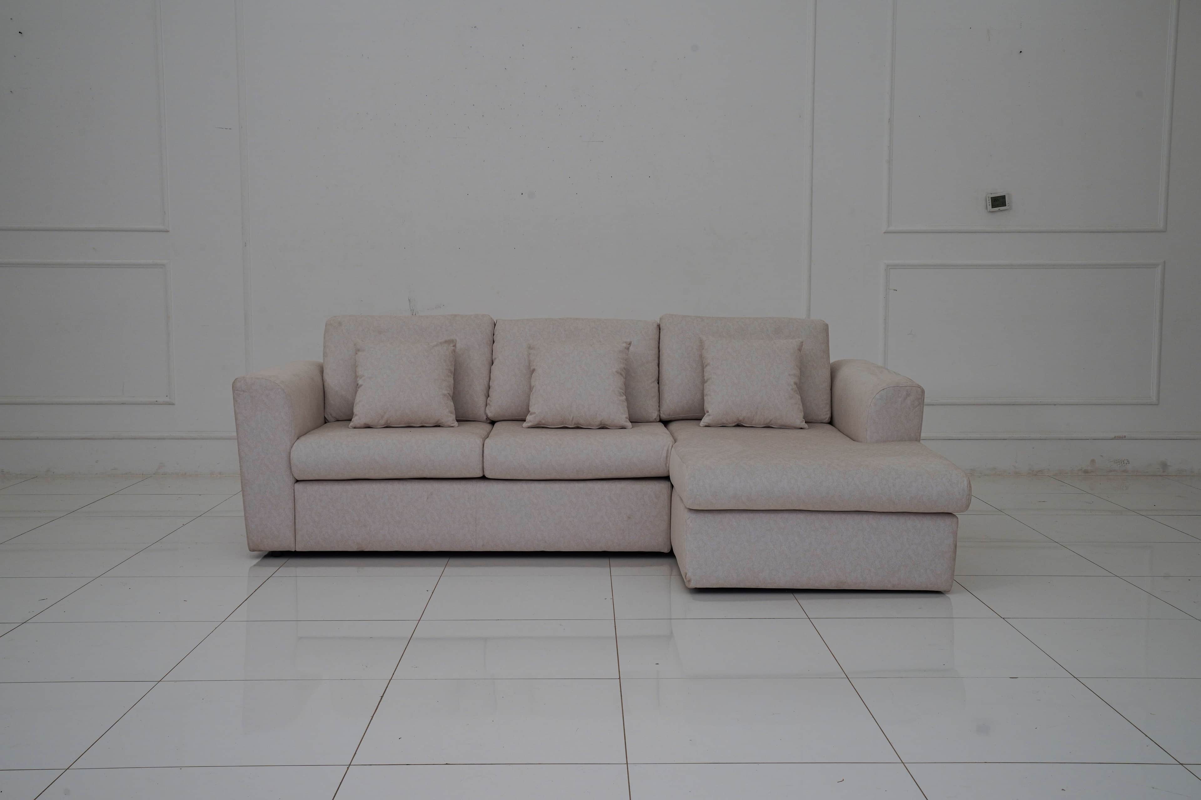 A sectional sofa with a chaise lounge extension, upholstered in a light-colored fabric with a subtle… — free OBJ 3D model