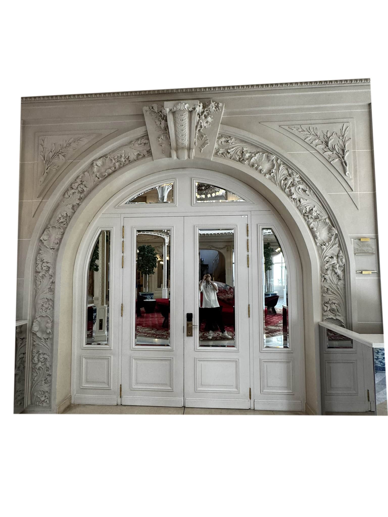 A large, ornate, double-door entryway framed by an elaborate arched stone surround. The doors are of… — 3D model