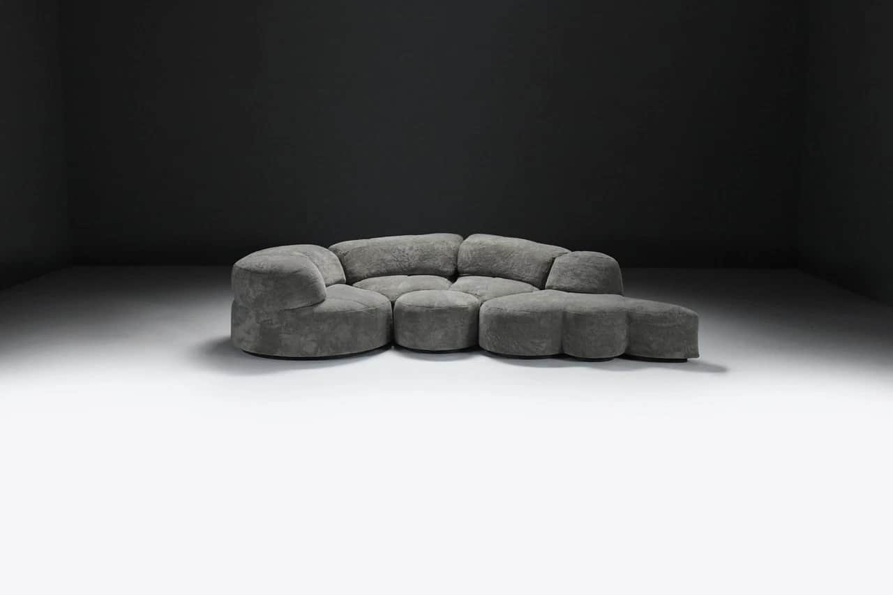 A large, multi-part sectional sofa featuring soft, organic, rounded forms, upholstered in a textured… — 3D model