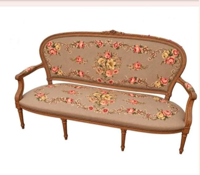 A two-seater settee featuring an elaborately carved exposed wooden frame and floral needlepoint upho… — 3D model