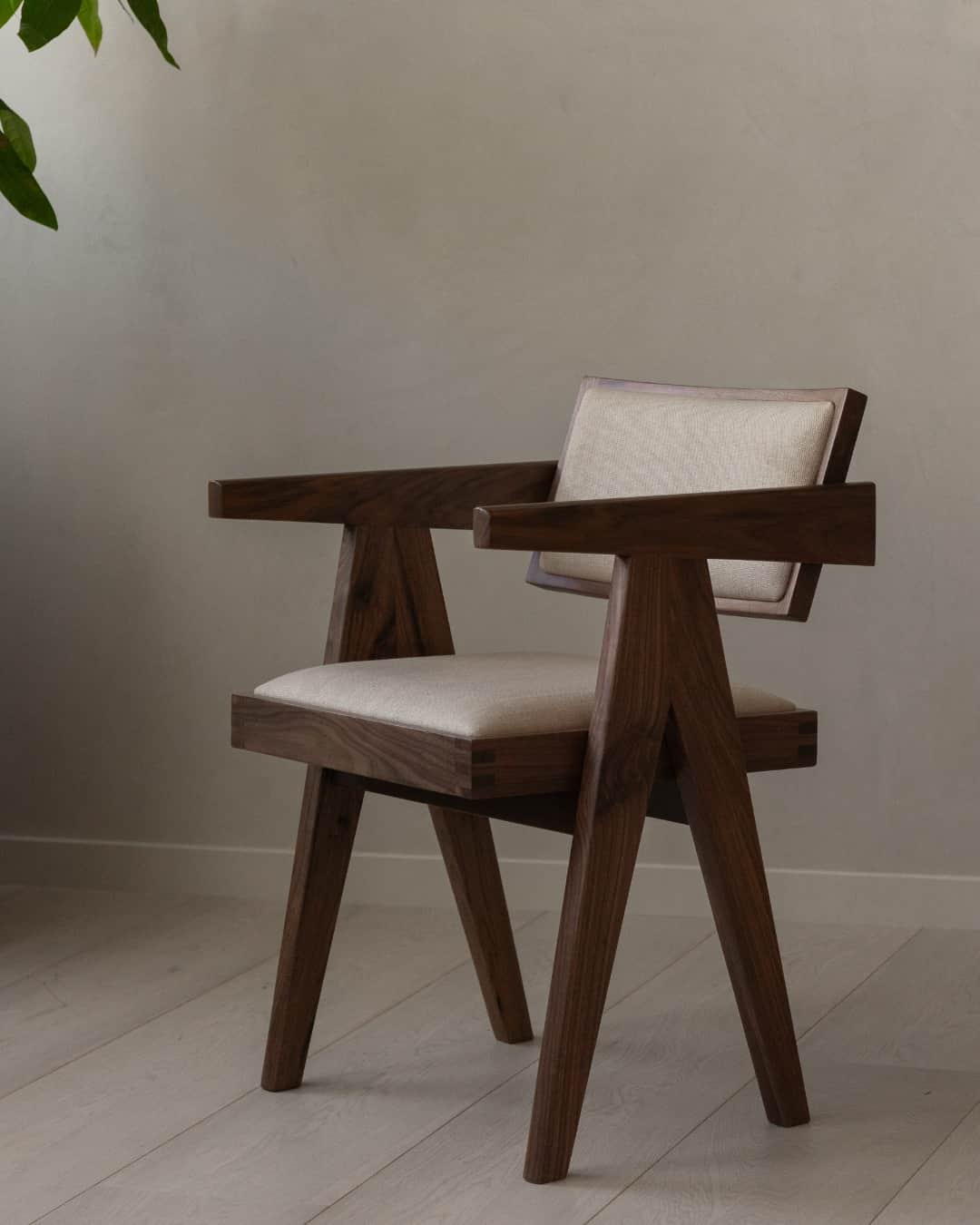 A modern armchair with a wooden frame and upholstered seat and backrest. The frame is constructed fr… — free OBJ 3D model