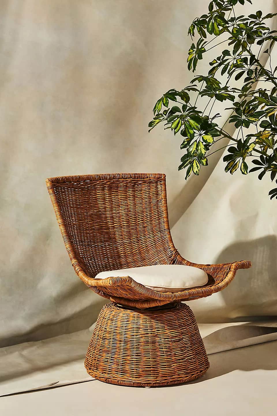 A vintage-style woven rattan swivel chair with a high back and a cylindrical base, featuring a light… — free OBJ 3D model