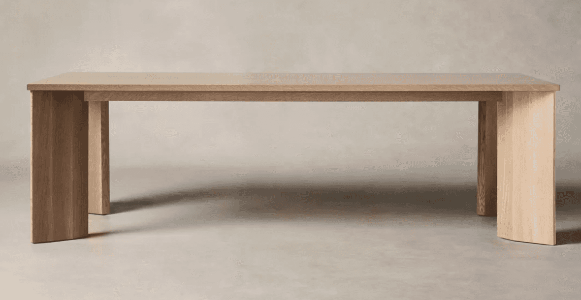 A robust, rectangular dining table crafted from light-colored wood, likely oak, featuring a thick ta… — 3D model