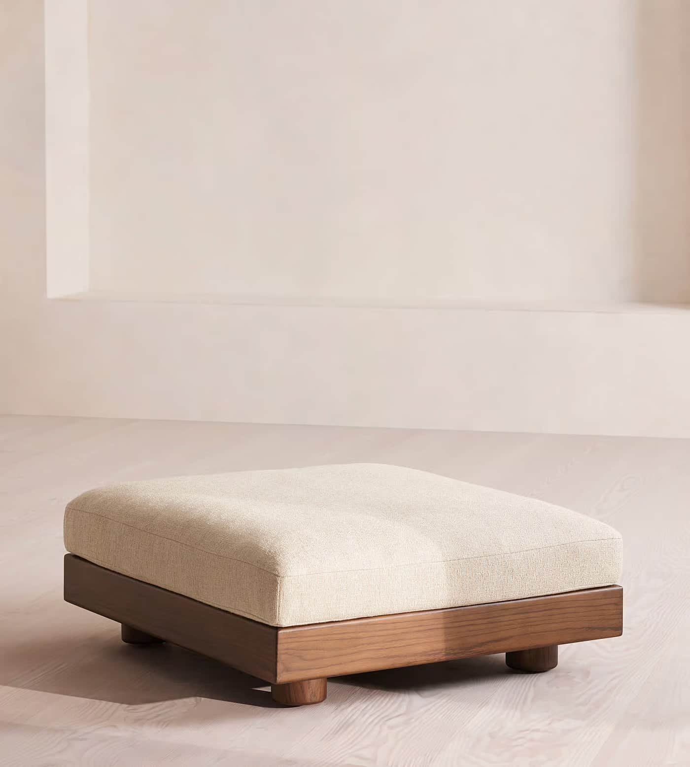 A rectangular ottoman with a cushioned top and a wooden base. The base has a low profile and is supp… — 3D model