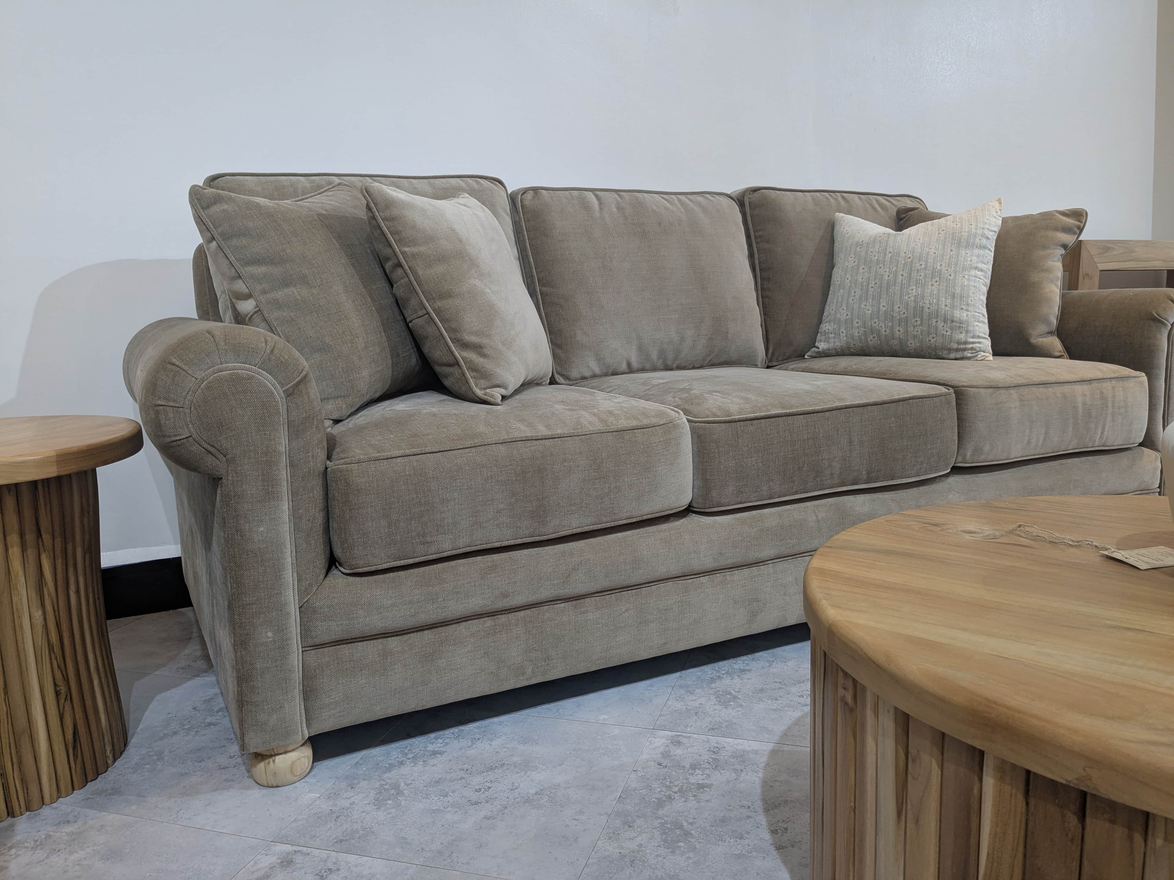 A traditional-style three-seater sofa upholstered in a neutral beige fabric, featuring classic rolle… — free GLTF 3D model
