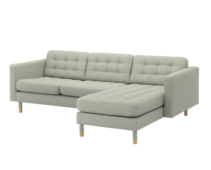 A light sage green fabric sectional sofa with a right-hand facing chaise lounge. The sofa features t… — 3D model