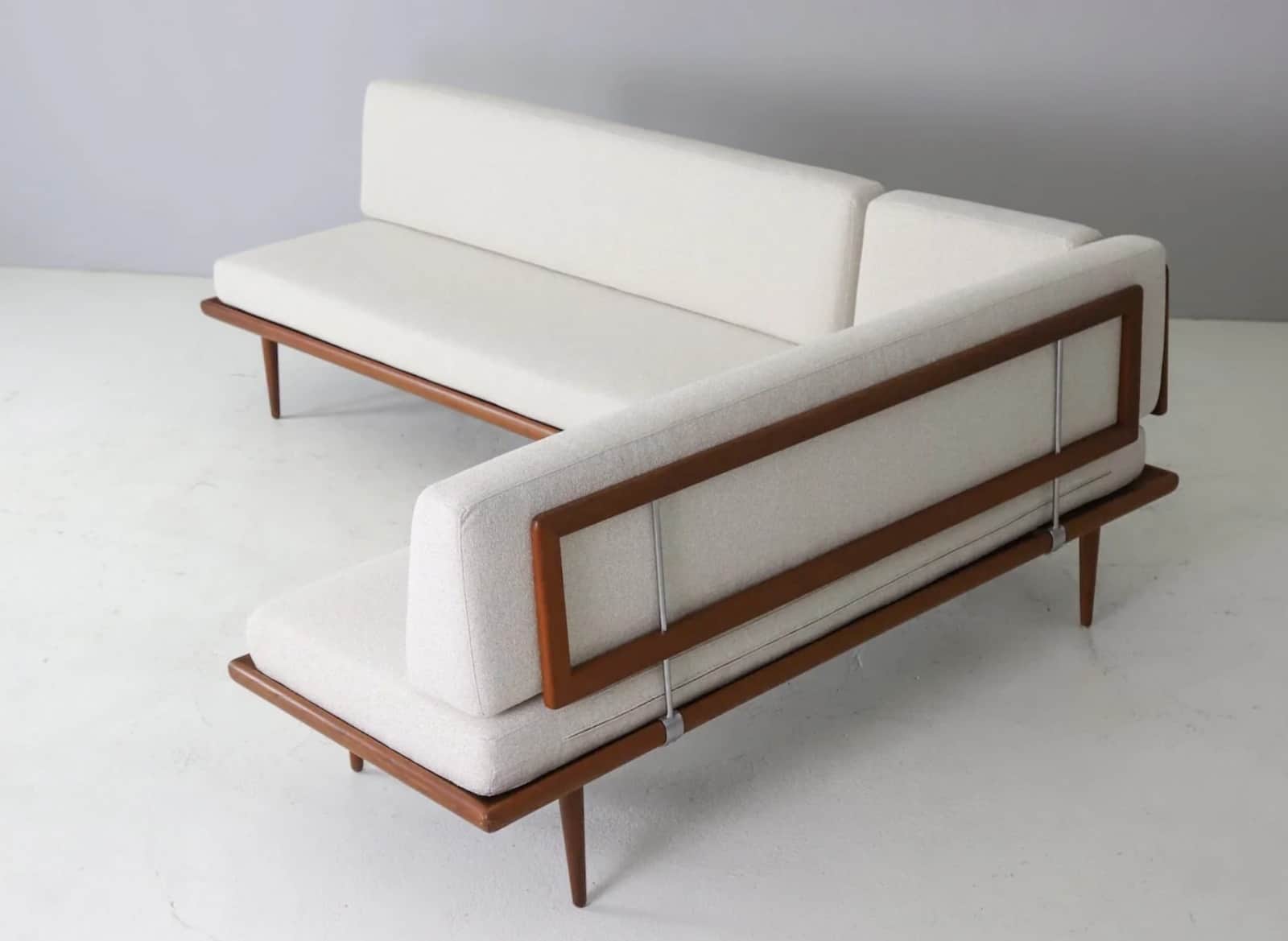 An L-shaped sectional sofa featuring an exposed dark-stained wooden frame, likely teak, supporting t… — free SKP 3D model