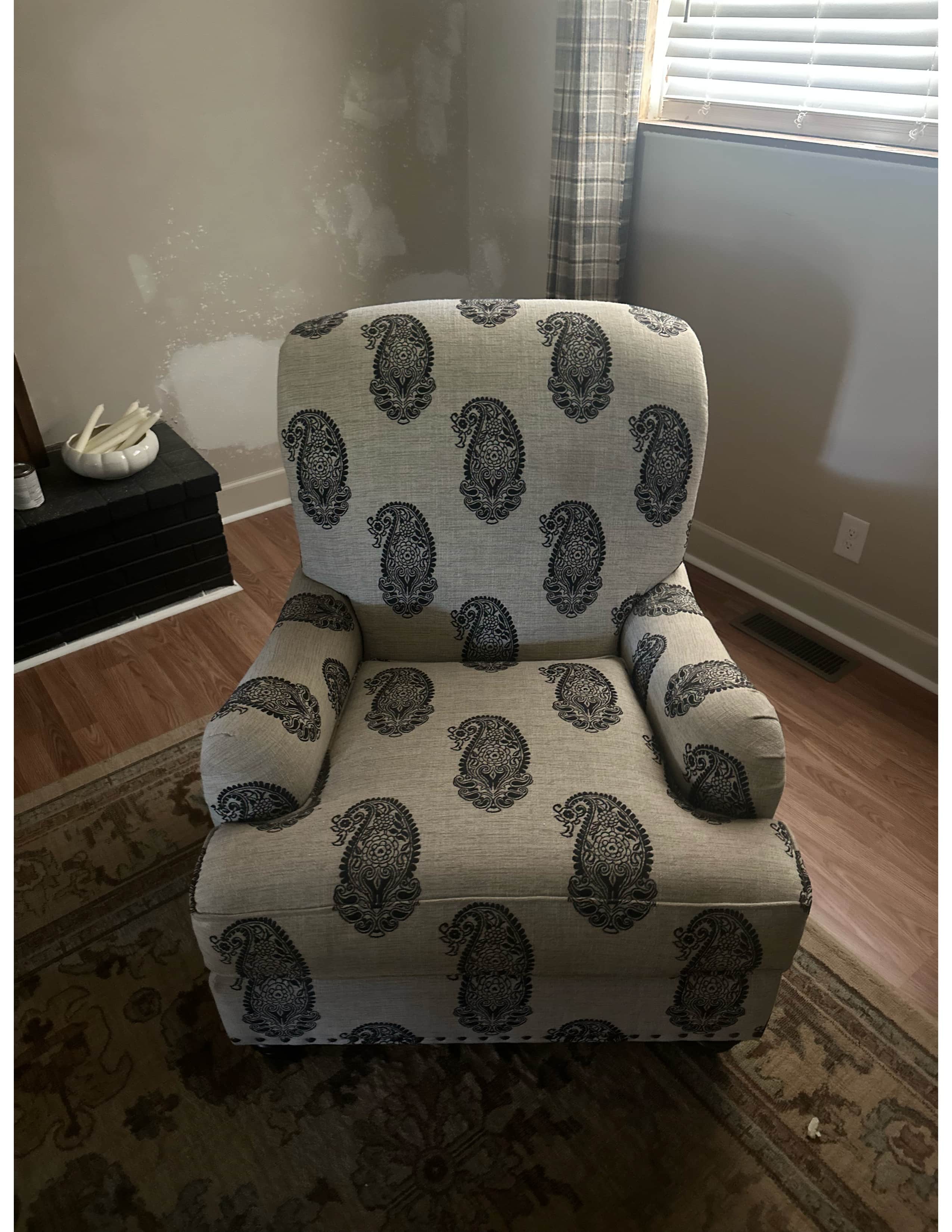 A single armchair upholstered in a neutral-colored fabric with a repeating paisley pattern in a dark… — 3D model
