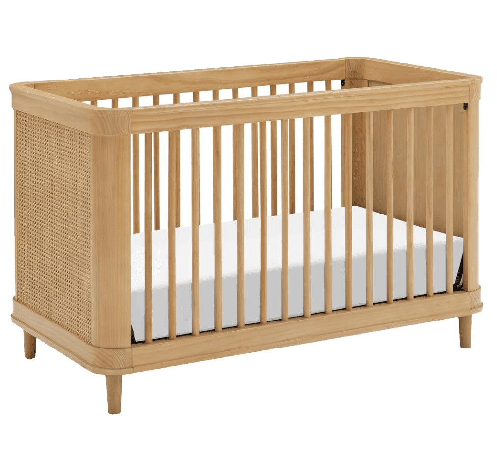 A wooden crib with a natural wood finish. The crib features a slatted design along the sides and fro… — 3D model