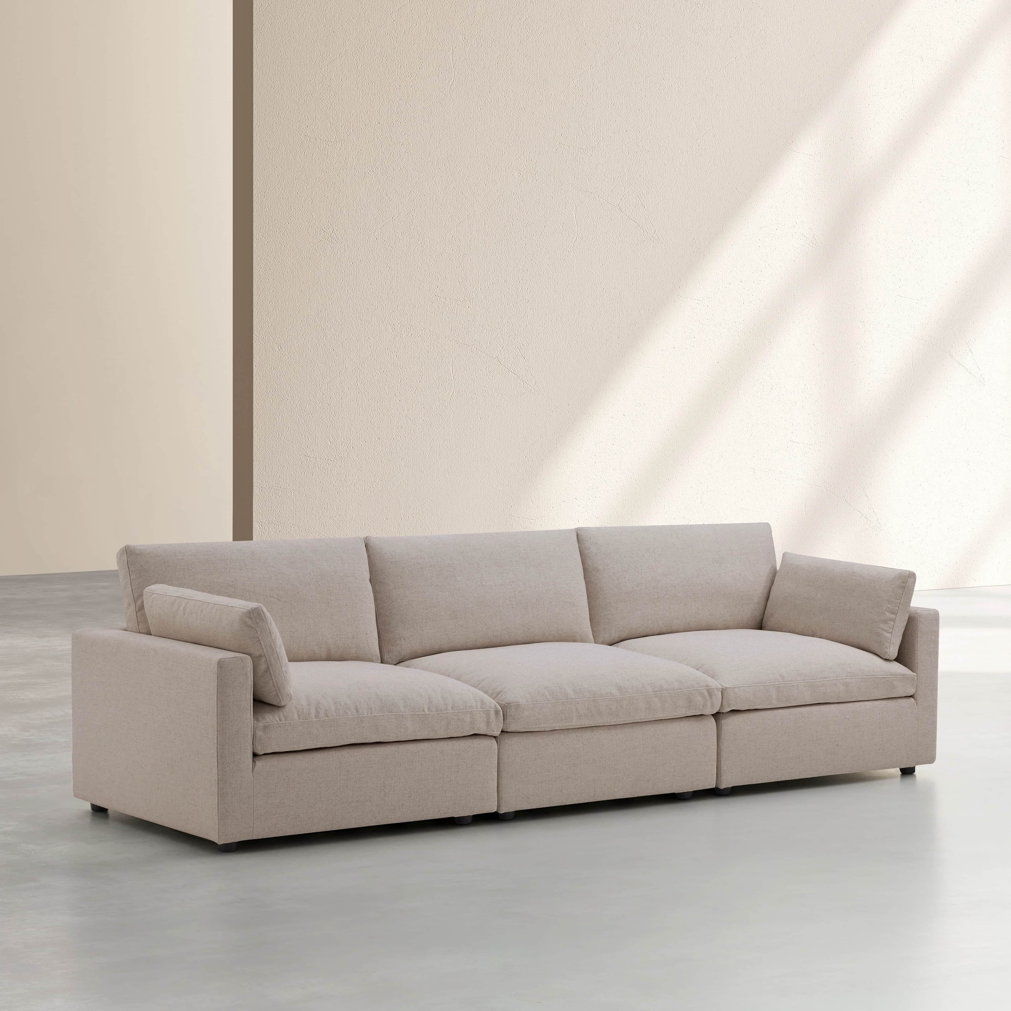 A three-seater sofa with a low profile and wide arms. The sofa features deep seat cushions and back… — free GLTF 3D model