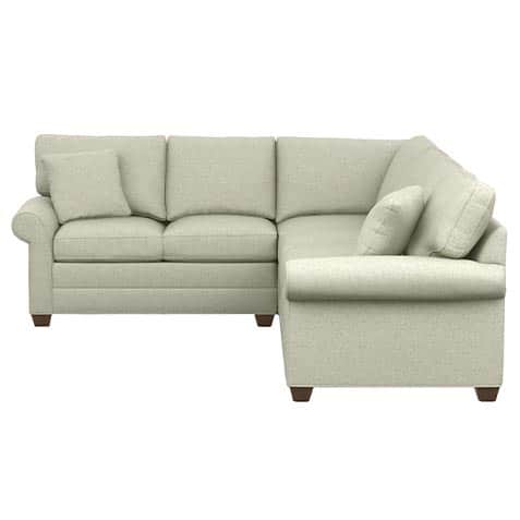 An L-shaped sectional sofa featuring a light, textured fabric upholstery. The design includes classi… — 3D model