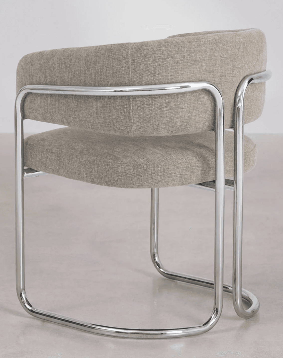 A modern armchair with a tubular chrome frame and upholstered seat and back. The frame consists of b… — 3D model