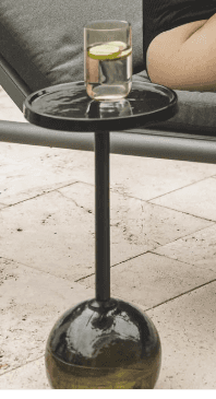 A modern outdoor side table featuring a round, shallow tray-style top, a slender cylindrical pedesta… — 3D model