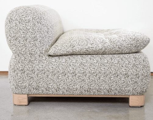 A contemporary armchair with a distinctive rounded silhouette. The piece is upholstered in a texture… — free OBJ 3D model
