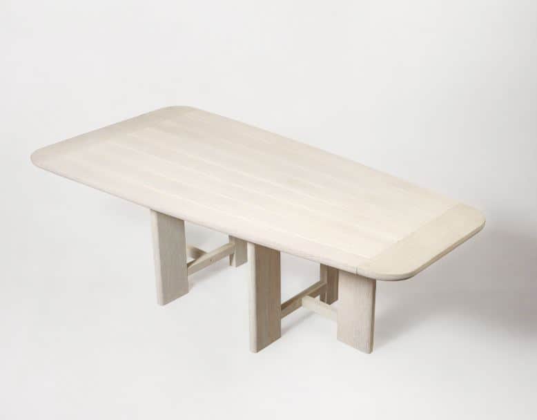 A rectangular dining table crafted from light-colored wood, featuring a slatted top with gently roun… — 3D model