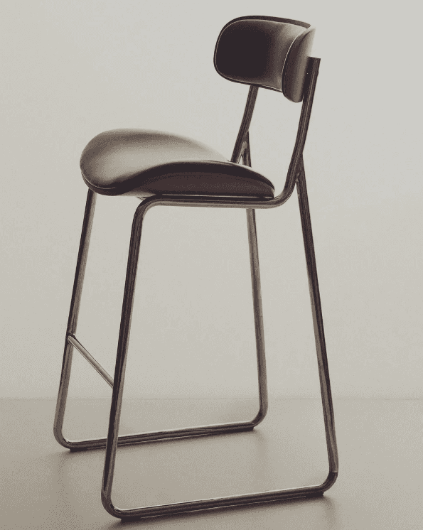 A modern bar stool featuring a bent plywood shell with black upholstered seat and backrest, supporte… — 3D model