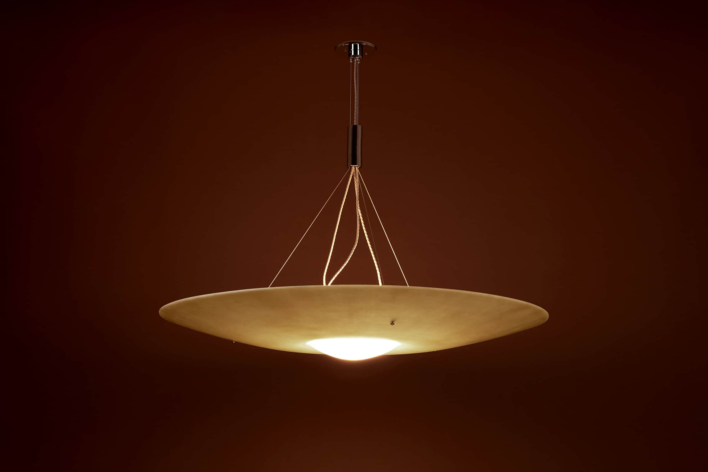 A contemporary chandelier featuring a wide, flattened disc-shaped shade in an off-white or cream col… — 3D model