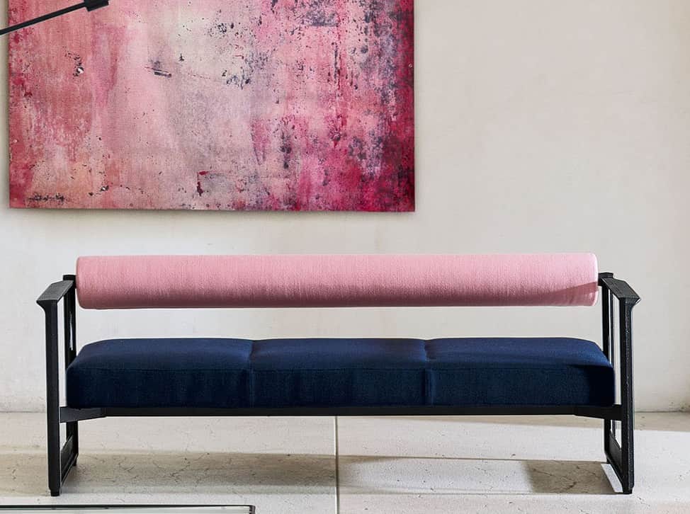 A modern bench featuring a minimalist black metal frame with dark blue upholstered seat cushions and… — 3D model