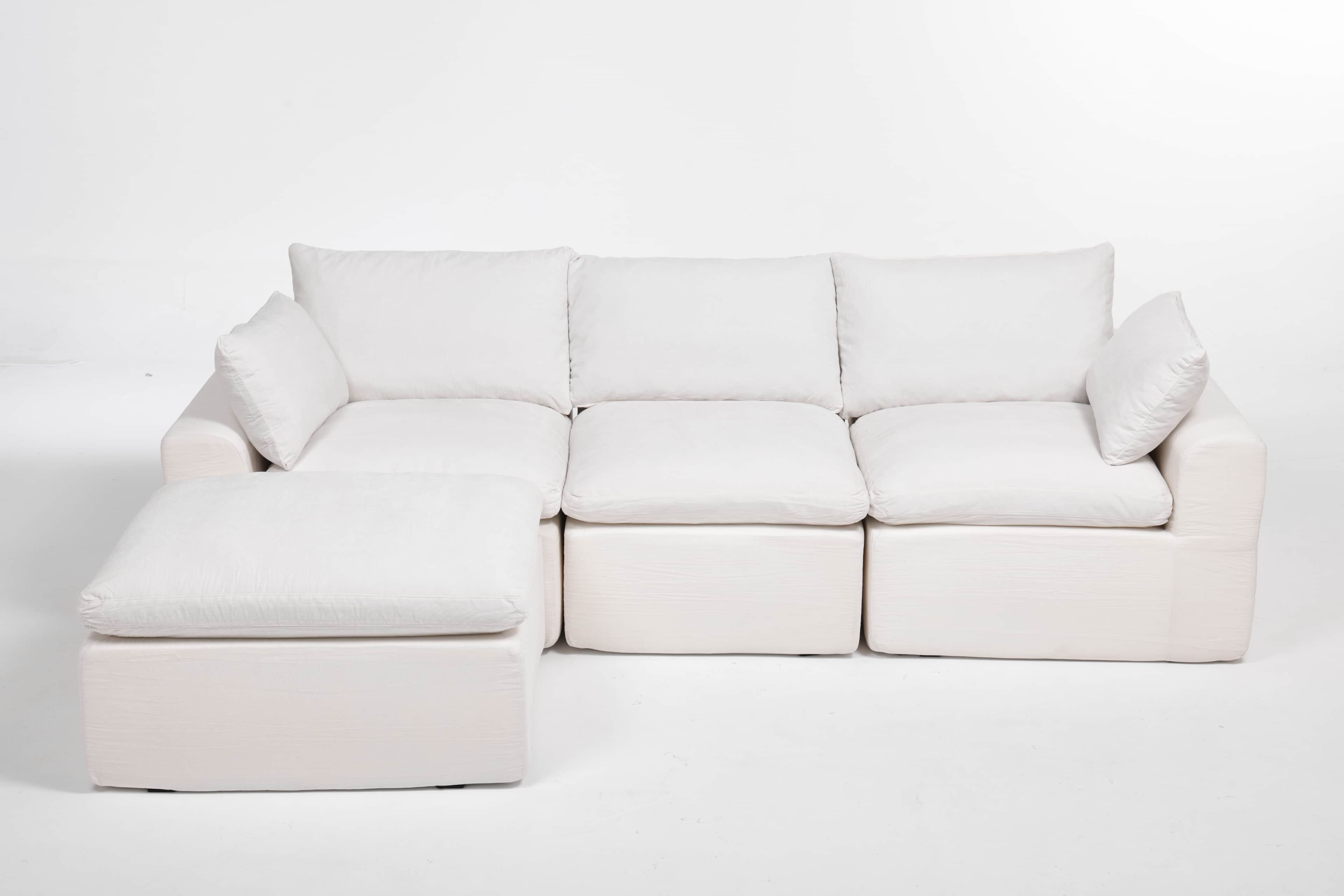 A modular sectional sofa with an attached ottoman. The sofa features deep, plush cushions and a low… — free GLTF 3D model
