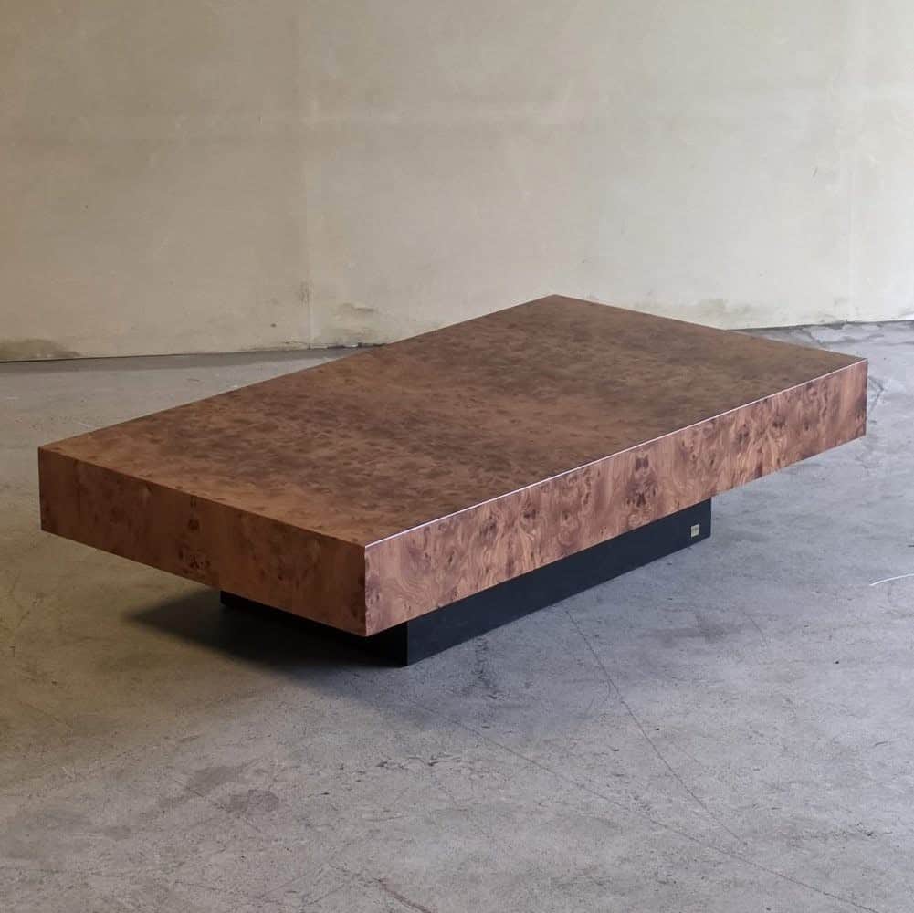 A rectangular coffee table with a burl wood veneer top and a dark, solid base. The burl wood pattern… — free BLEND 3D model