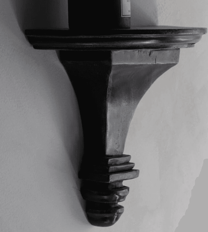 A dark brown, semi-circular wall shelf with a decorative, carved bracket. The shelf has a subtle cur… — 3D model