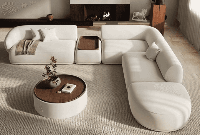 A multi-piece modular sectional sofa upholstered in a light, neutral fabric, featuring rounded edges… — 3D model