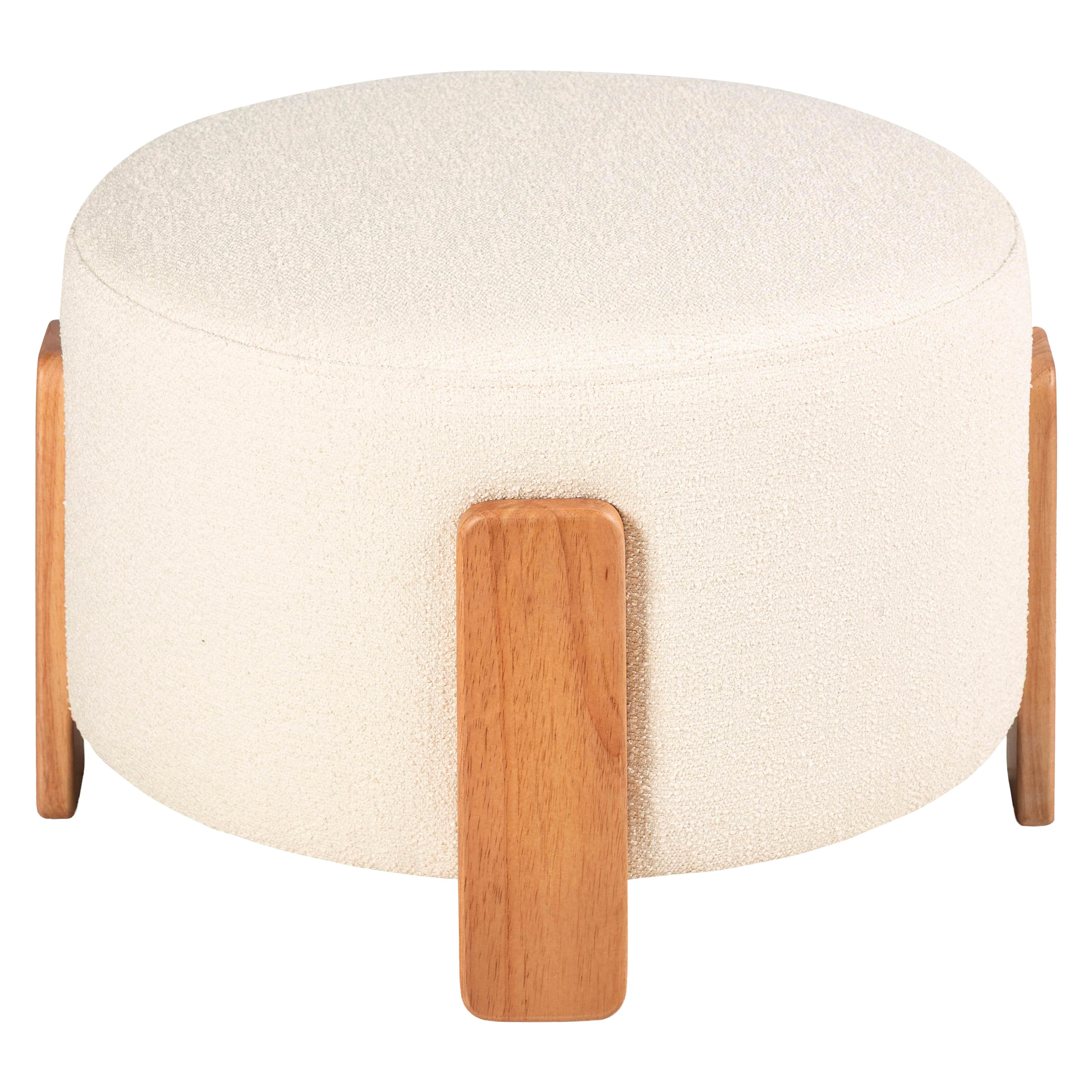 A contemporary round ottoman featuring a textured off-white upholstery and supported by three sturdy… — free GLTF 3D model