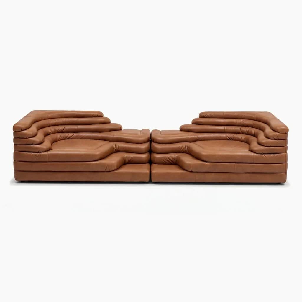 A modular, low-profile sofa composed of two symmetrical sections, each featuring a unique, layered d… — 3D model