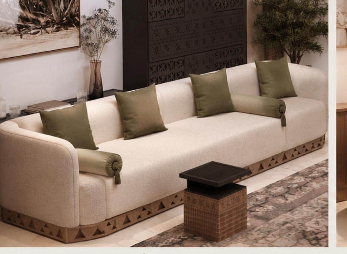 A contemporary three-seater sofa upholstered in light-colored bouclé fabric with rounded edges and a… — 3D model