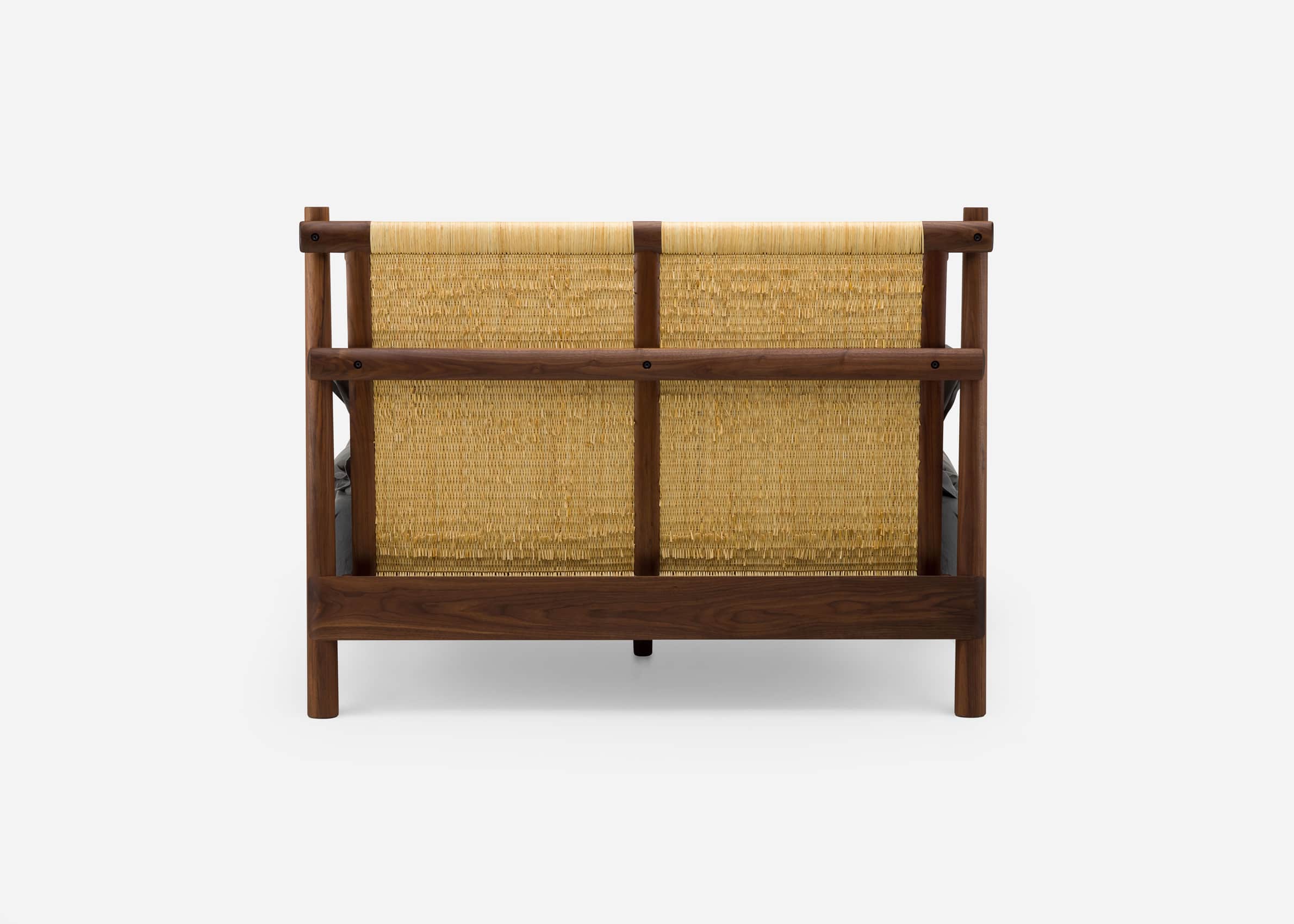 A loveseat seen from the back, featuring a dark walnut wood frame and a light-colored woven natural… — 3D model