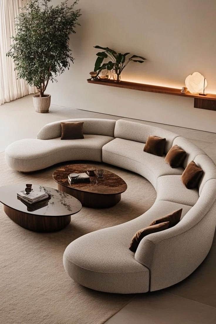 A large, modular, curved sofa with a low profile. The sofa features rounded edges and is upholstered… — free GLTF 3D model