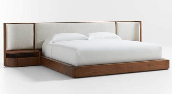 A modern platform bed featuring a dark wood frame, a wide upholstered headboard, and integrated floa… — 3D model
