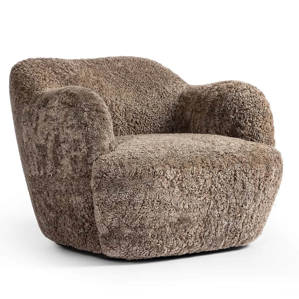 A plush, upholstered armchair with a rounded, organic silhouette. The piece features a thick, textur… — free GLTF 3D model