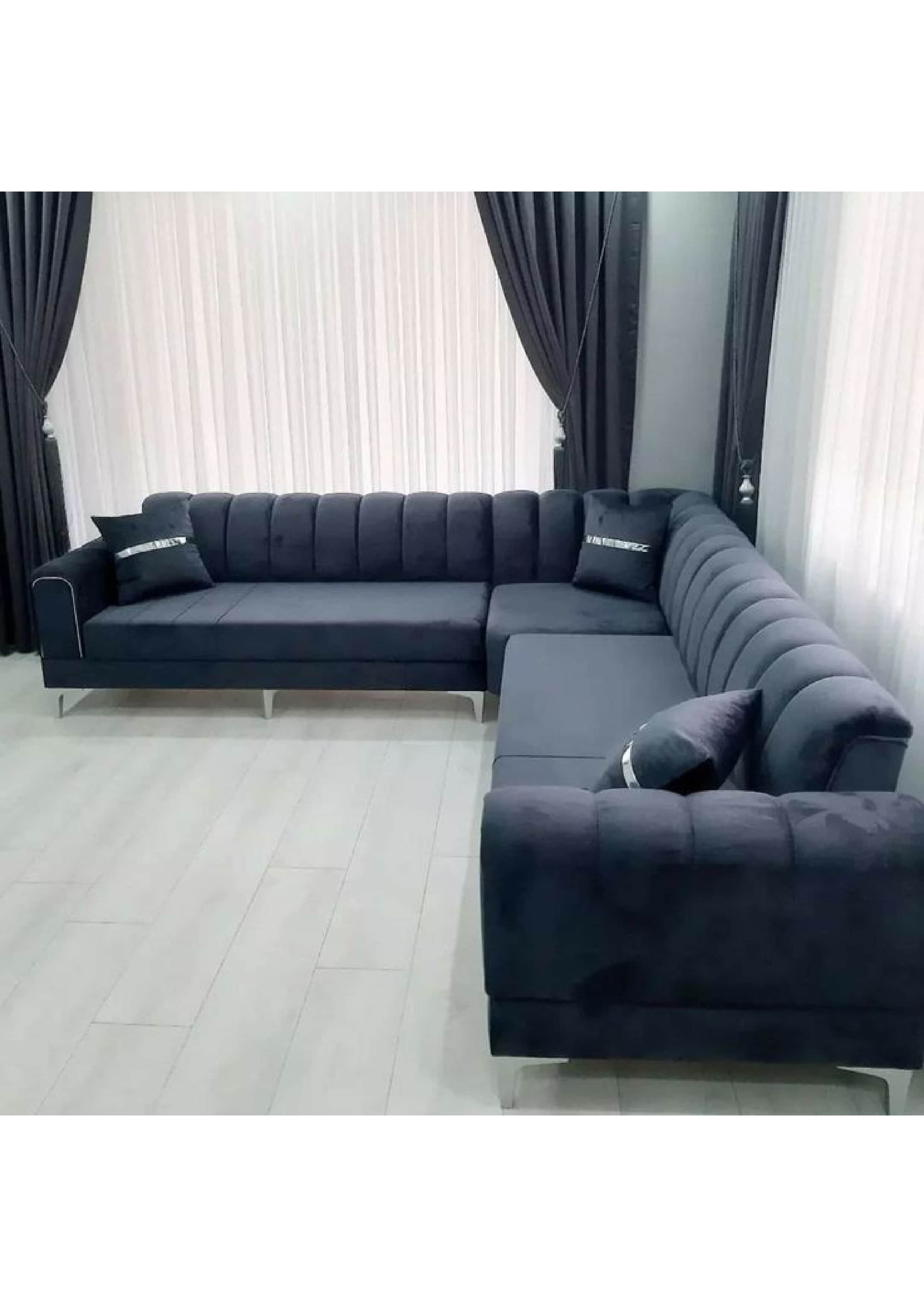 A modern L-shaped sectional sofa in a dark gray upholstery, featuring vertical channel tufting on th… — 3D model