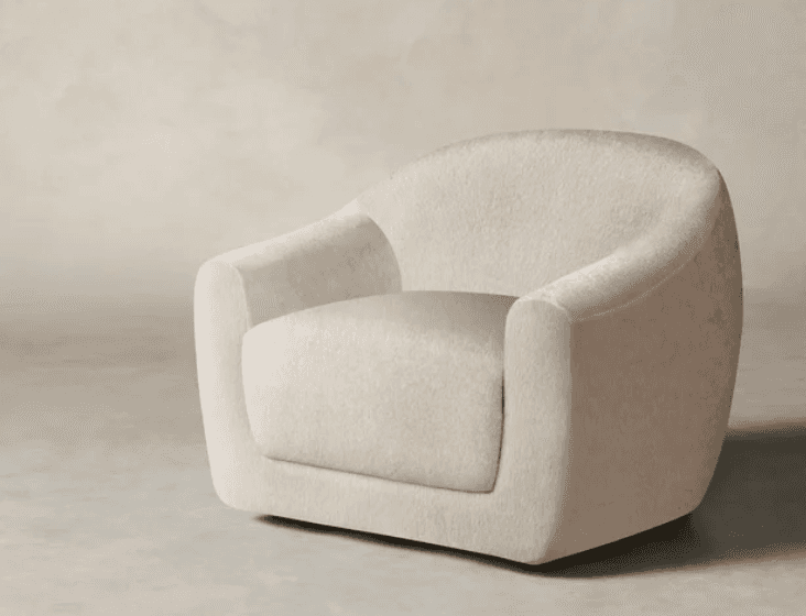A contemporary, fully upholstered lounge chair in a light, textured boucle fabric, featuring a round… — 3D model