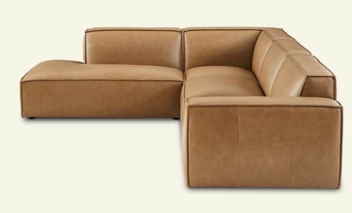 A modular sectional sofa with a left-hand facing chaise lounge, upholstered in camel-colored leather… — 3D model