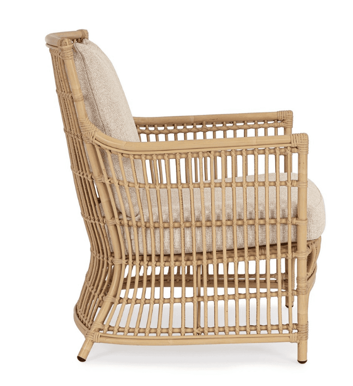 A light brown natural rattan lounge armchair featuring a curved, open-weave frame. It is fitted with… — 3D model