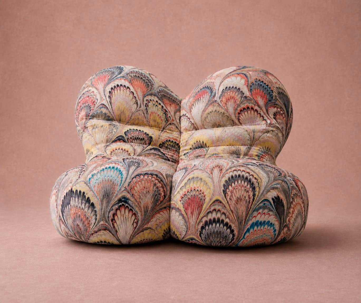 A deeply tufted, modular lounge seating unit upholstered in a vibrant, multi-colored marbled fabric.… — 3D model