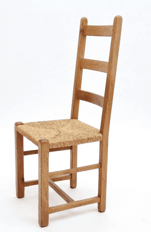 A traditional-style wooden dining chair featuring a ladder-back design and a woven rush seat, presen… — 3D model