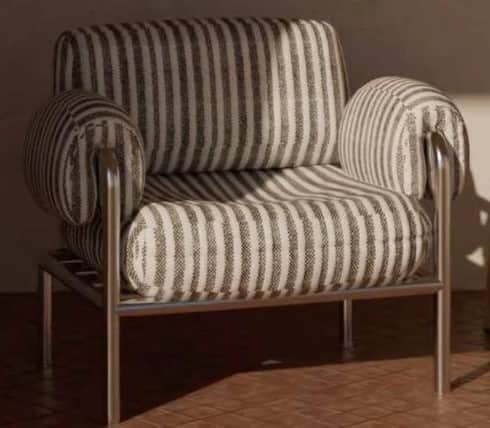A modern armchair featuring a robust metal frame and plush, striped fabric upholstery. The chair has… — 3D model