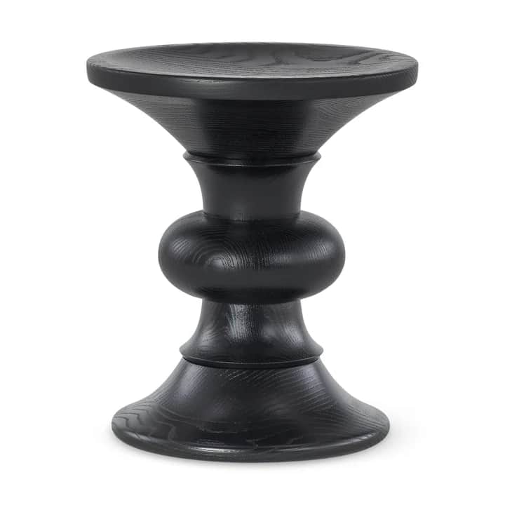 A dark-colored wooden stool with a unique, sculptural design. The stool features a circular top that… — 3D model