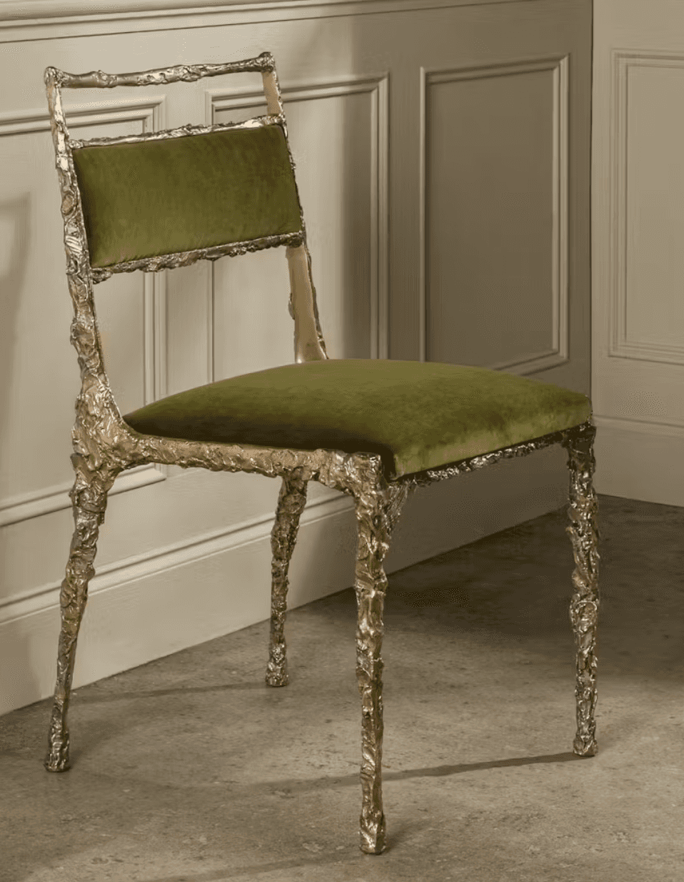 An armless side chair featuring a highly textured, organic silver cast metal frame and olive green v… — 3D model