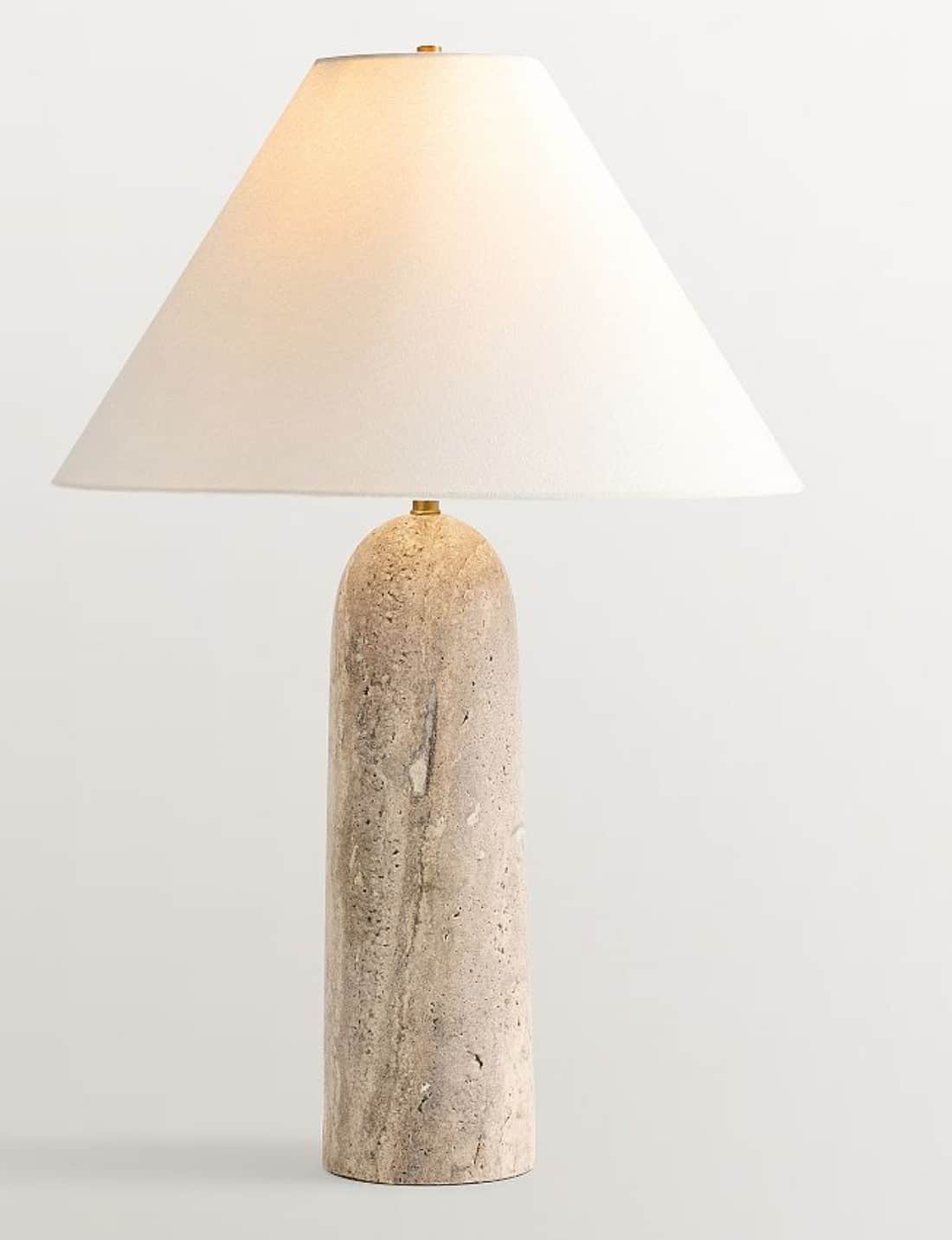 A contemporary table lamp featuring a solid, cylindrical base crafted from natural travertine stone,… — 3D model