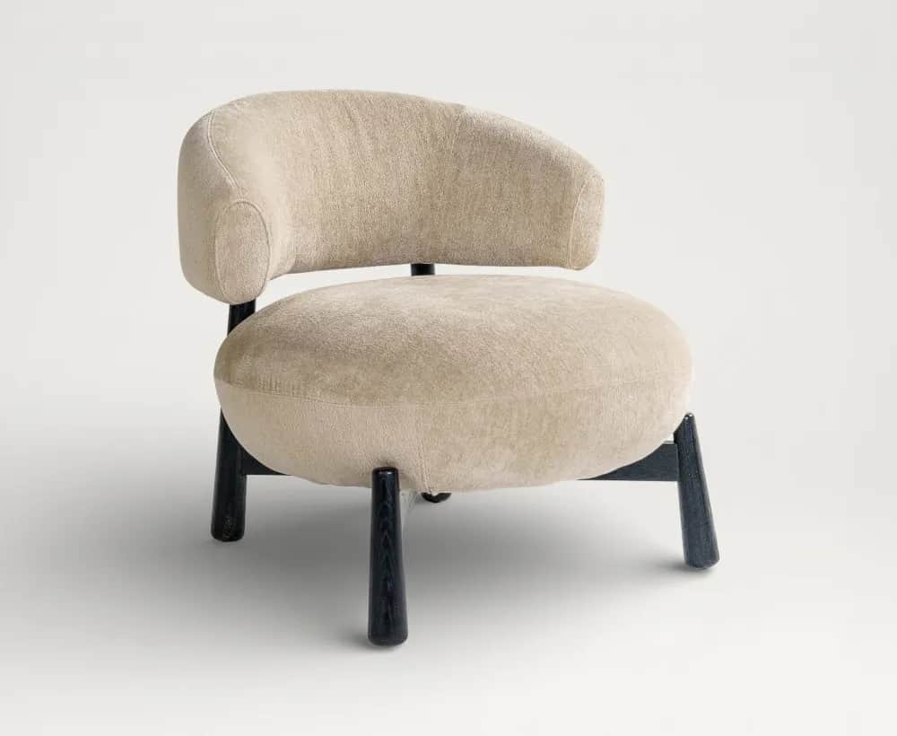 An upholstered barrel-shaped accent chair featuring a rounded back and seat, supported by four dark,… — free OBJ 3D model