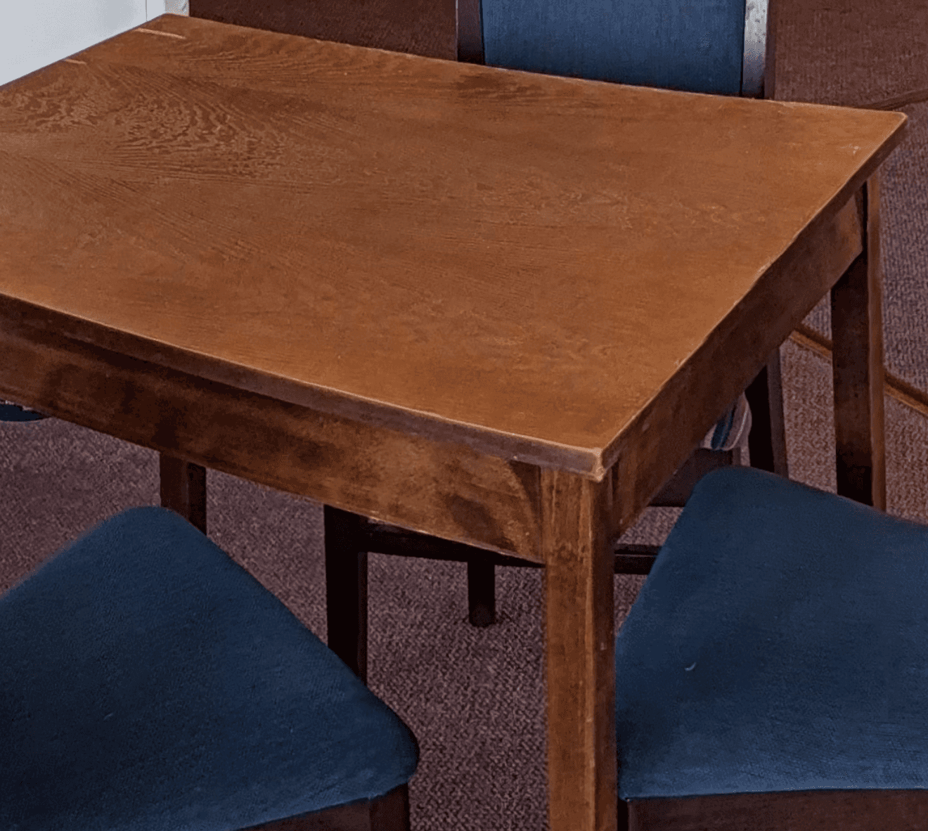 A simple, rectangular wooden table with a medium brown finish, featuring a flat tabletop and four st… — free GLTF 3D model