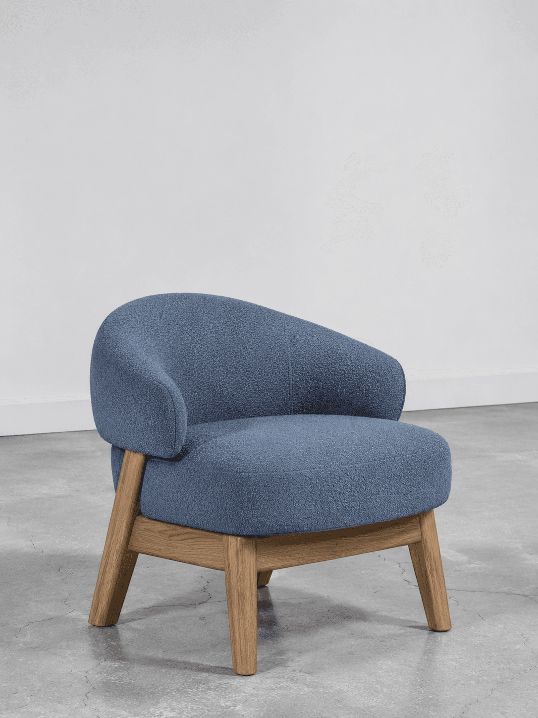 A single-seater chair featuring a rounded, continuous backrest and armrests, upholstered in a textur… — 3D model