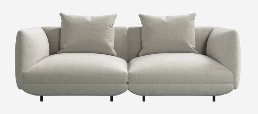 A contemporary two-seater modular sofa upholstered in a light beige fabric, featuring a plush, round… — 3D model