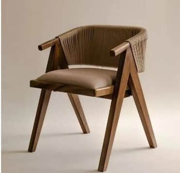 A contemporary armchair featuring a solid wood frame, a curved backrest with tightly woven natural r… — free STL 3D model